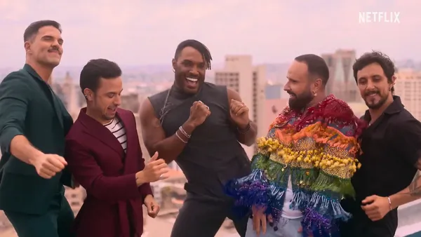 Five men share joyful moments on a rooftop in Queer Eye Brazil.