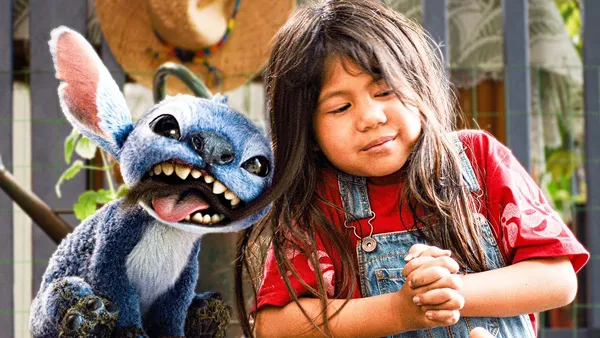 Stitch shows sharp teeth next to Lilo in "Lilo & Stitch (2025)".