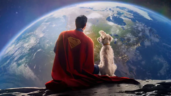 Superman and a dog gaze at Earth from the Moon in "Superman (2025)".