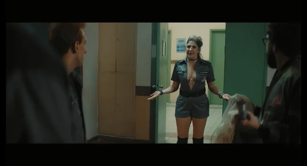 Hallway scene in "Exterminadores do Além Contra a Loira do Banheiro" with a uniformed woman.